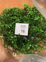 Artificial greenery garland, full circular shape, showing dense small leaves in various shades of green.