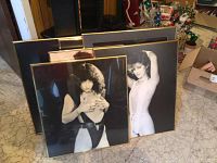 Photo shows seven framed pin up prints stacked and leaning against wall, largest size about 27x22 inches.
