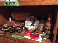 Group photo showing the covered wagon shot glass holder, eagle collector plate, and other decor items