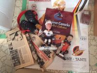 Overview showing signed poster with tear, bobble heads, ear muffs, medallion booklet, and hockey memorabilia