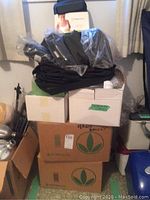 Stacked boxes labeled Herbalife with some black cases on top