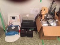 Lot items arranged showing portrait lamps, mannequin head, lock boxes, scales