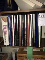 Shelf display of assorted self-help and course books and DVD cases including Evolution of Art & Music, Mandel, and Best of Decker titles.