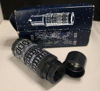 Photo showing the black cylindrical Stellarscope with white markings and the open end cap, along with the original box in the background.