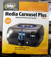 Front of box showing product image, brand and model, disc capacity, and LED lighting feature.