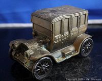 Side view showing the full shape of the car coin bank and details like the windows and wheels