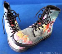Front side of the boots showing colorful artistic patterns and black laces.