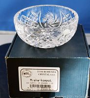 Hand cut lead crystal bowl displayed on top of original box showing detailed cut patterns and label.