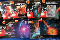 Full display of all 8 Star Trek LaserDiscs and the wooden disc carrier showing front cover artwork for each movie.