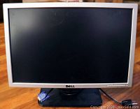 Full frontal photo of the Dell 19-inch widescreen silver LCD monitor with black stand, power cable, and VGA cable attached.