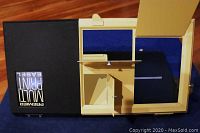 Top view of the Premier Multi Print Easel showing multiple paper holding slots, one with lid open, revealing hinges and hardware.