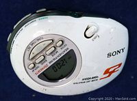Front view of the compact Sony SRF-M85W handheld digital stereo radio showing the digital display and control buttons including weather/FM/AM presets and tuning controls.