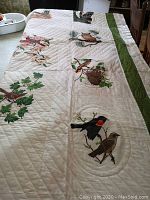 Full view of quilt laid out on surface showing overall design and border