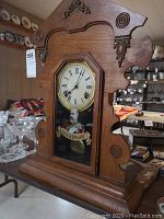 Full front view of oak case, dial, glass door and base