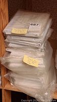 Stacked plastic-wrapped quilt blocks, note indicating rose pattern 7 dozen