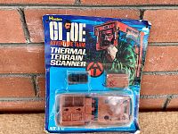 Front of original packaging with all accessories visible inside clear blister pack, showing thermal terrain scanner and related parts.