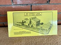 Yellow box top showing illustration of coal company building, branding and text