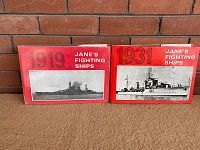 Two volumes side-by-side showing front covers with red dust jackets and black and white ship images and publication years 1919 and 1931