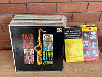Stack of vintage jazz vinyl records with visible front cover of Stan Getz and Horace Silver's "Pair of Kings" album and an RCA Victor jazz encyclopedia booklet.