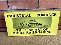 Top of yellow box with “INDUSTRIAL ROMANCE – The Fine Art of Model Railroading” artwork
