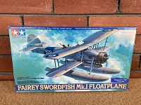 Photo of the sealed box of the Tamiya Fairey Swordfish Mk.I Floatplane model kit showing box art and markings.