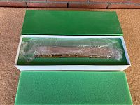 Green lid removed, locomotive wrapped in plastic inside foam-lined white box