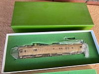 Original green Overland Models box opened to show foam insert and brass detector car sealed in plastic wrap.