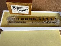 Vintage brass Heavyweight Pullman train car in original box, wrapped in plastic, showing detailed brass finish and window openings.