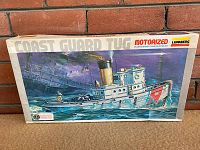 Front of the vintage Lindberg Line Coast Guard tug boat model kit box, showing artwork and branding details.