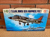 Front view of the unopened model kit box featuring artwork of Royal Navy Sea Harrier FRS.1 in flight with naval ship background, displaying details like wingspan and fuselage size.