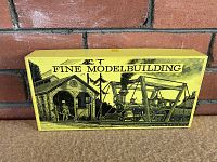 Closed rectangular yellow box top showing 'Fine Modelbuilding' illustration of locomotive and crew