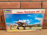 Front of the box displaying the Revell 1/32 scale Hawker Hurricane Mk. IIC plastic model kit with box art showing a painted aircraft and pilot figure.