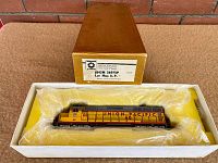 Gold Oriental Limited cardboard box opened to reveal locomotive in foam tray wrapped in plastic.