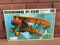 Front view of model kit box with artwork showing Boeing P-12E US Army Pursuit Plane by Hasegawa in 1/32 scale.