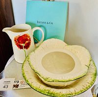Photo of the Tiffany & Co. ceramic pitcher with red poppy flower and matching bowl and container with embossed leaf pattern and green accents.