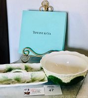Tray and bowl set displayed before Tiffany & Co. blue box on easel stand.