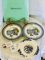 Two Tiffany & Co. bicentennial decorative plates with White House and horse-drawn carriage design and one blue and white floral peony bowl, displayed with Tiffany & Co. box.