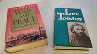 Front covers of two vintage Tolstoy books: War and Peace and a biography.