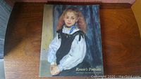 Front cover of the art book showing profile portrait of a young girl with blonde hair in white blouse and black pinafore, titled 'Renoir's Portraits' by National Gallery of Canada.