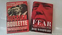 Front covers of two hardcover political books about Donald Trump and Vladimir Putin.
