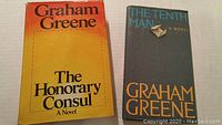 Front cover of two Graham Greene novels: 'The Honorary Consul' and 'The Tenth Man'