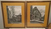 Pair of framed black and white prints showing Old Montreal architectural scenes with yellow matting and gold-finished wooden frames, signed by R.D. Wilson 1964.