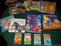Photo showing 22 children's books laid out including Disney Pixar 5-minute stories, Bedtime Sing to Me, Franklin series and Arthur series books, children's truck and dinosaur themed titles.