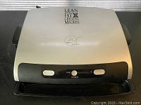 Closed view of George Foreman grill top showing logo and control buttons