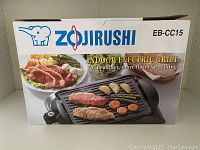 The original box of the Zojirushi indoor electric grill with product image and branding