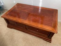 Top view of the wooden coffee table showing the decorative wood veneer surface and inlaid border.