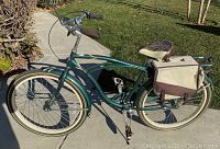 Full side view of green Huffy bicycle with saddle bag