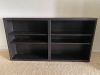 Front view showing two main compartments with two adjustable shelves each, black finish.