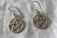 Front view of the pair of sterling silver pentagram earrings showing the pentagram design and hook backing.