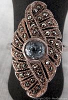 Top view of vintage sterling silver ring showing marquise shape design with central blue stone and surrounding marcasite stones.
